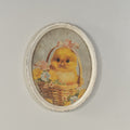 OVAL FRAMED CHICK IN BASKET WITH FLOWERS PRINT